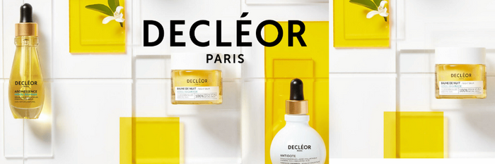 Decléor Paris skincare products on a white background with yellow accents